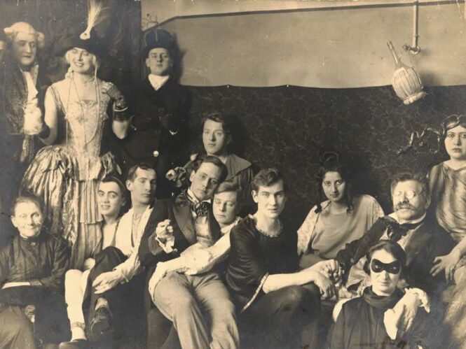 b/w antique photo of group of friends sitting together informally  