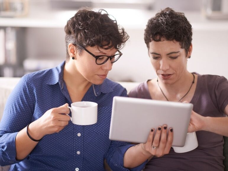 two women looking at a tablet screen