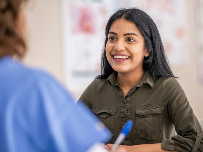 enthusiastic patient taking notes with a doctor