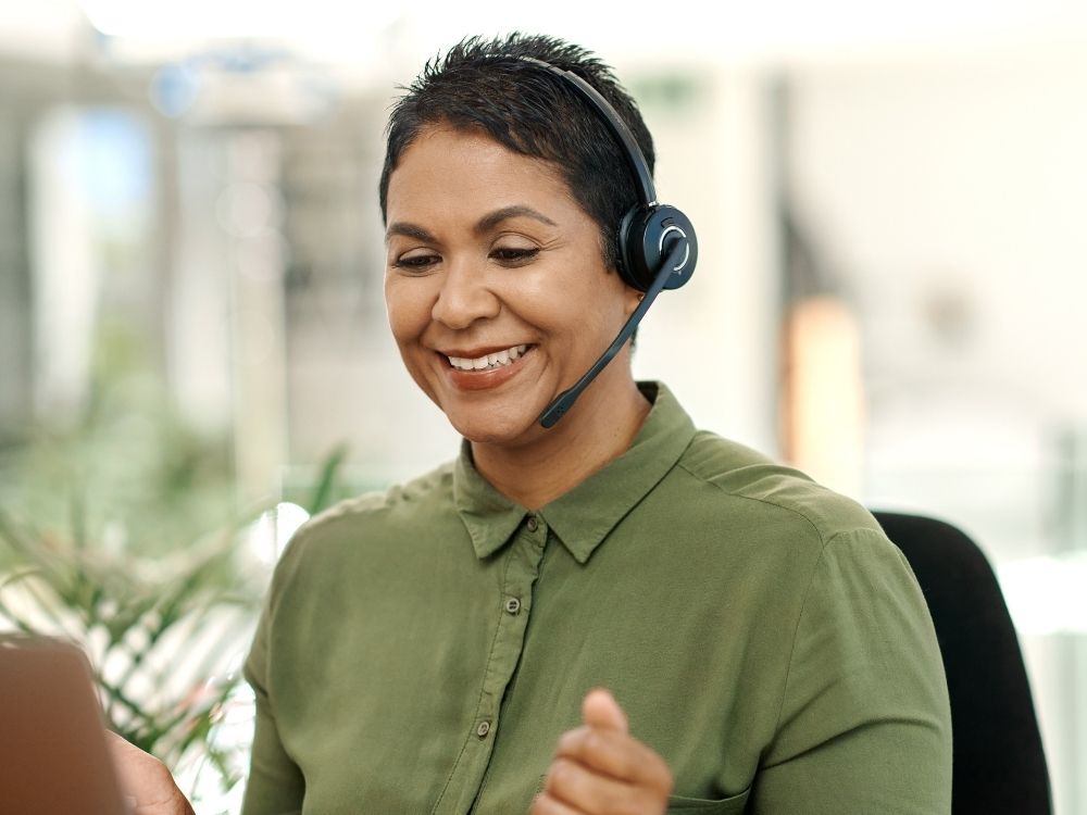 smiling woman wearing call headset