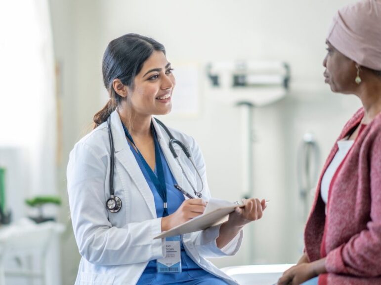 smiling doctor talking to a patient