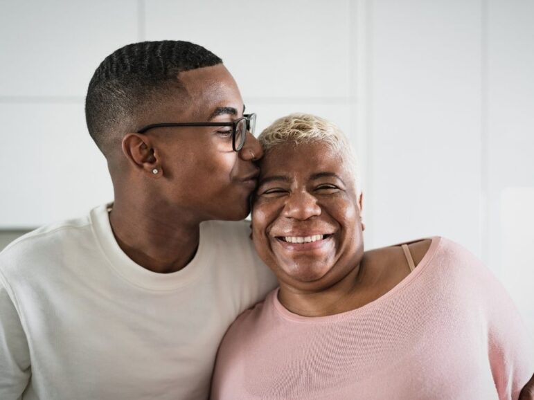 son embracing his happy mother