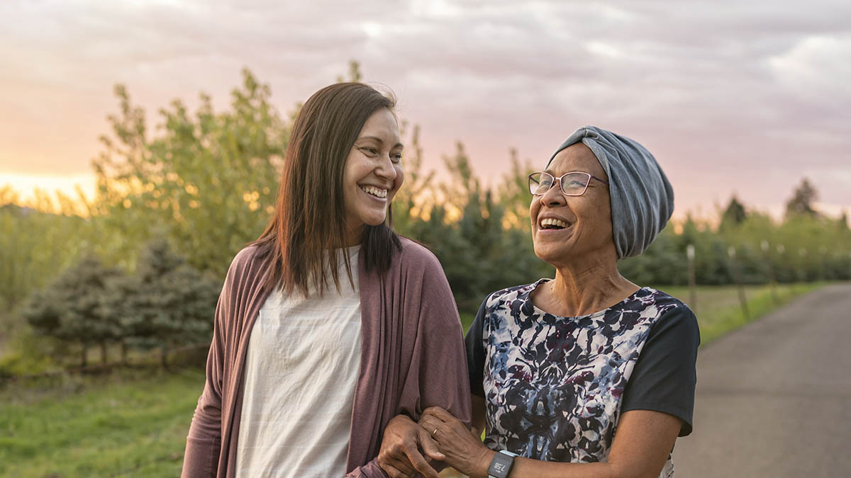 two smiling family members on a walk