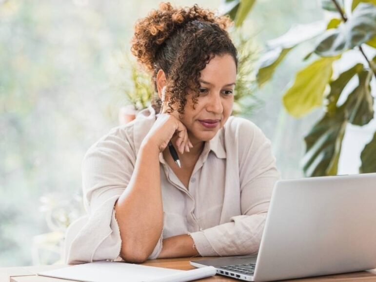 focused woman taking notes