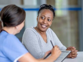 smiling woman talking to a healthcare professional