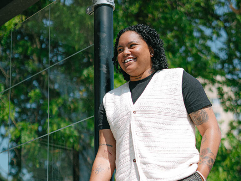 smiling nonbinary person of color