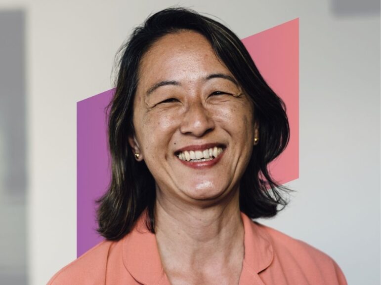 smiling woman in orange shirt
