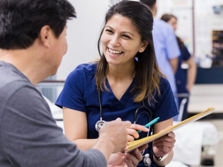 happy doctor talking to male patient