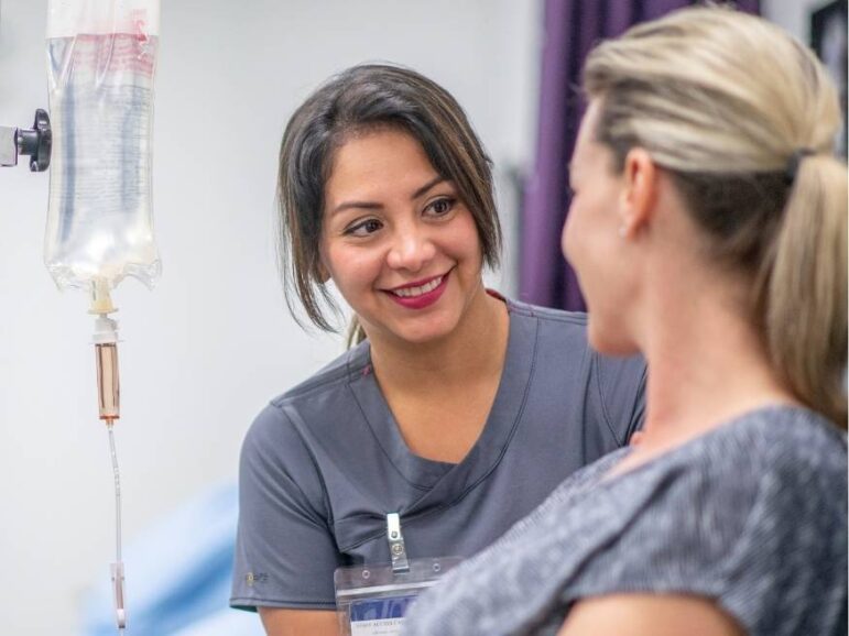 female nurse taking care of woman with IV