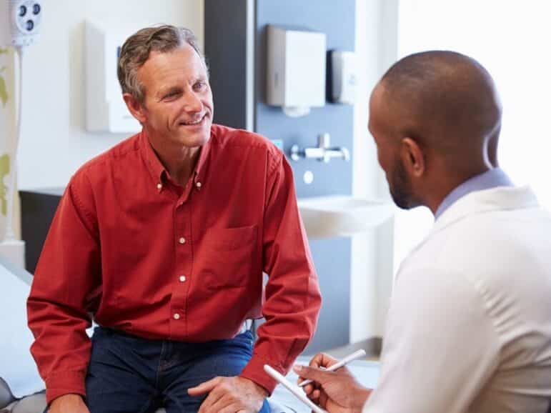 male patient talking to male doctor